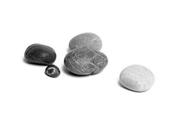 Scattered sea pebbles. Heap of smooth gray and black stones isolated on white background