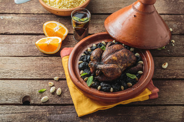 Chicken tajine with prunes and almonds, moroccan cuisine, copy space.
