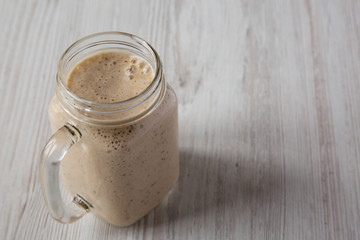 Banana, kiwi, apple smoothie with chia seeds in a glass jar, low angle view. Copy space.