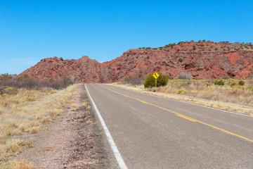 Fototapeta na wymiar Deserted desert highway with rocks