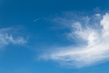 ground view of commercial airplane looking up view clear sky clouds