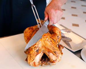 a chef carving roast turkey in a live display