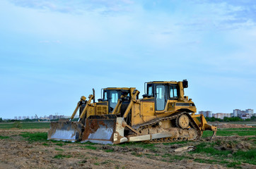 Obraz na płótnie Canvas Track-Type Tractors, Bulldozer, Earth-Moving Heavy Equipment for Construction - Image