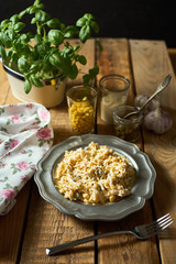 Salad of grated cheese with capers and corn  with basil on wooden table