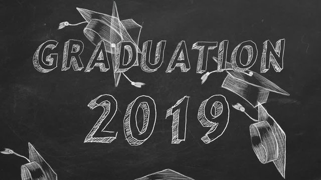 Hand drawing "Graduation 2019" and graduation caps on blackboard