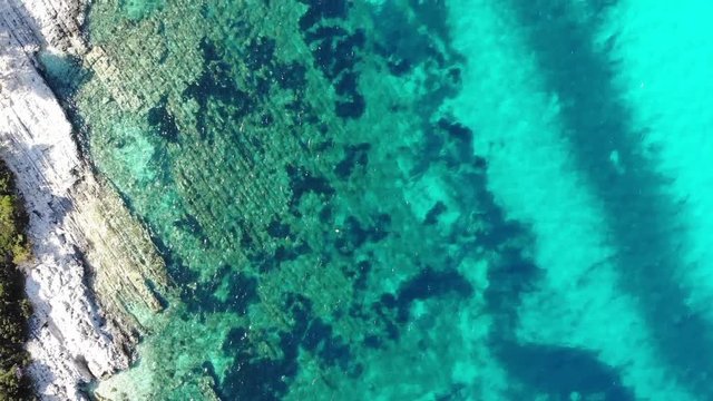 Drop down view footage following crystal clear water on adriatic coast.