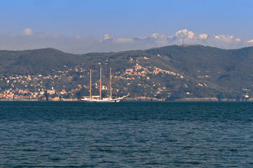 Sailing ship in the Mediterranean in the background of the Alps mountains