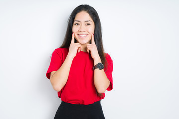 Fototapeta premium Beautiful brunette woman wearing red t-shirt over isolated background Smiling with open mouth, fingers pointing and forcing cheerful smile