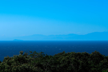 Blue landscape with mountains and sea