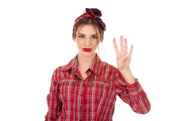 Fototapeta premium Young girl counting four over pure white background