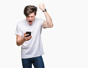 Young man using smartphone over isolated background annoyed and frustrated shouting with anger, crazy and yelling with raised hand, anger concept