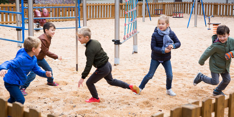 Smiling children playing romp game Touch-last