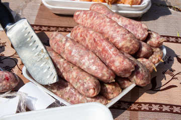 Home-made pork sausages for kebabs. Barbecue Sausage Knife