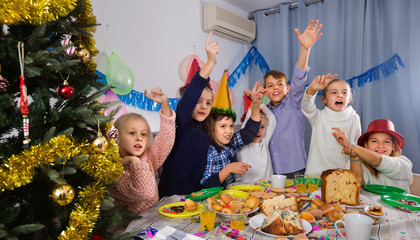 Fototapeta na wymiar Boys and girls behaving jokingly during friend’s birthday party
