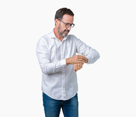 Handsome middle age elegant senior business man wearing glasses over isolated background Checking the time on wrist watch, relaxed and confident