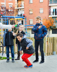 Positive kids playing in jump rope game
