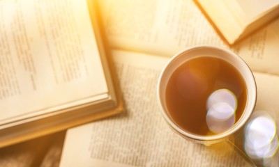 Notebooks and cup of strong coffee on wooden background.
