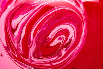 Texture of nail polish. Red marble background. Sample cosmetic product.