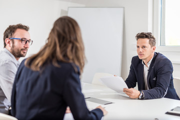 Fototapeta premium Business partners sitting at the desk in conference room and discussing