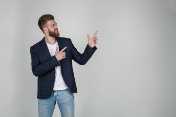 Positive young male freelancer or blogger being satisfied with results of work, has friendly...