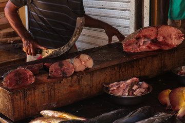 Man with knife on fish market,  closeup