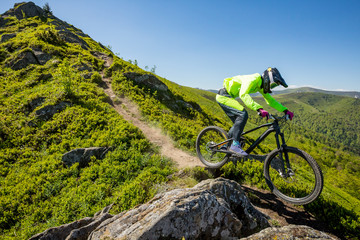 Fototapeta na wymiar Professional athlete is riding enduro bicycle on a beautiful rocky trail.
