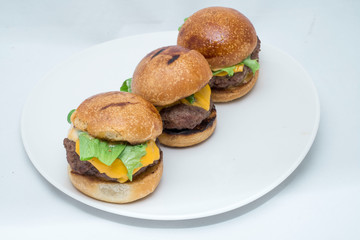 Hamburger sandwich with cheese, vegetables and sausage