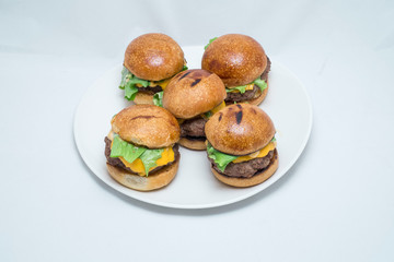 Hamburger sandwich with cheese, vegetables and sausage