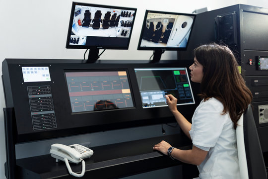 Female Doctor Monitoring Hyperbaric Oxygen Therapy In Control Room.