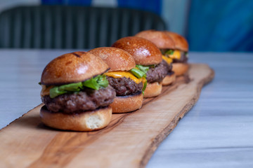 Hamburgers lined on Wood