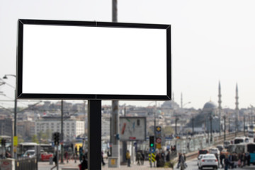 Big advertising sign on the street. People and tram way in background