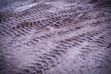 polluted snow on the road with car traces with vignette. background, seasonal.