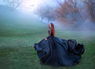 mysterious girl with red hair runs from forest in gorgeous lace royal dress with flying light long...