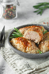 Delicious grilled beef meatballs. Meat patties on the little frying pan served with rosemary