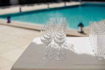 Champagne glass with dining set prepare dinner on table by the swimming pool