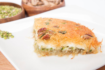 traditional turkish künefe dessert slice on plate