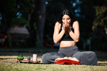 Young woman does yoga in the nature.