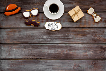 Happy Father Day with hat, glasses, moustache cookies, gift and coffee on wooden background top view mockup