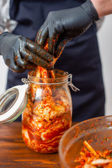 Preparing Kimchee with brightly colored ingredients. 