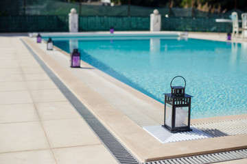 Candle lantern near the pool's edge on a summer's day, Portugal