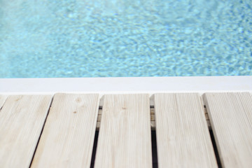 Swimming pool side with blue water background