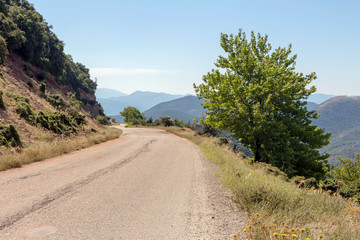 Fototapeta na wymiar A narrow, rural road in the mountains