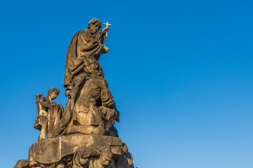 Obraz premium Beautiful delicate and elaborate sandstone Christian religion sculpture, statue of Saint Francis Xaverius, placed on the balustrade of Charles Bridge, Karlův most, in Prague, Czech Republic.