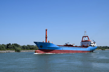 Cargo ship (bulk carrier) floats on the Danube river. Sulina, Danube Delta, Romania.
