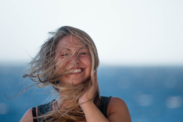 portrait of a woman on a boat / hair blowing in the wind 