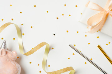 Girls party accessories over the white background. Festive stuff, confetti stars, ribbon, pink unicorn, gift box. Invitation, birthday, bachelorette party, baby shower, hen party concept
