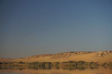 Aswan, Egypt: The west bank of the Nile River on a clear, cloudless morning.