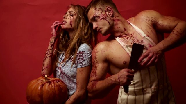 Sexy Vampire Woman with blood. Vampire girl and man. Horror halloween background people in bloody costume.