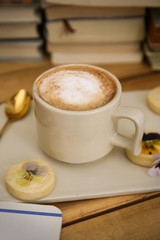 cup of cafe latte and old books