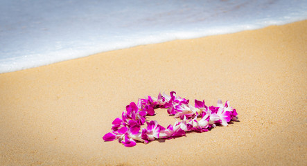 Orchid Lei on a Maui beach with soft surf